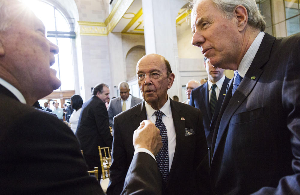 Georgia Governor Nathan Deal, left, talks with US Commercer Secretary Wilbur Ross, center, and John Irving, who, along with his brother Robert is CEO of Irving Consumer Products, following the announcement of a new Irving toilet tissue plant for Macon. 