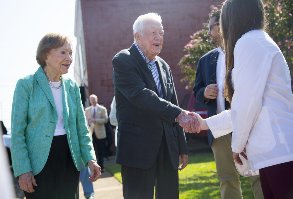 Rosalynn and Jimmy Carter greet one of the Mercer University medical students on hand to officially open the new Mercer medical clinic in the Carters' home of Plains. 