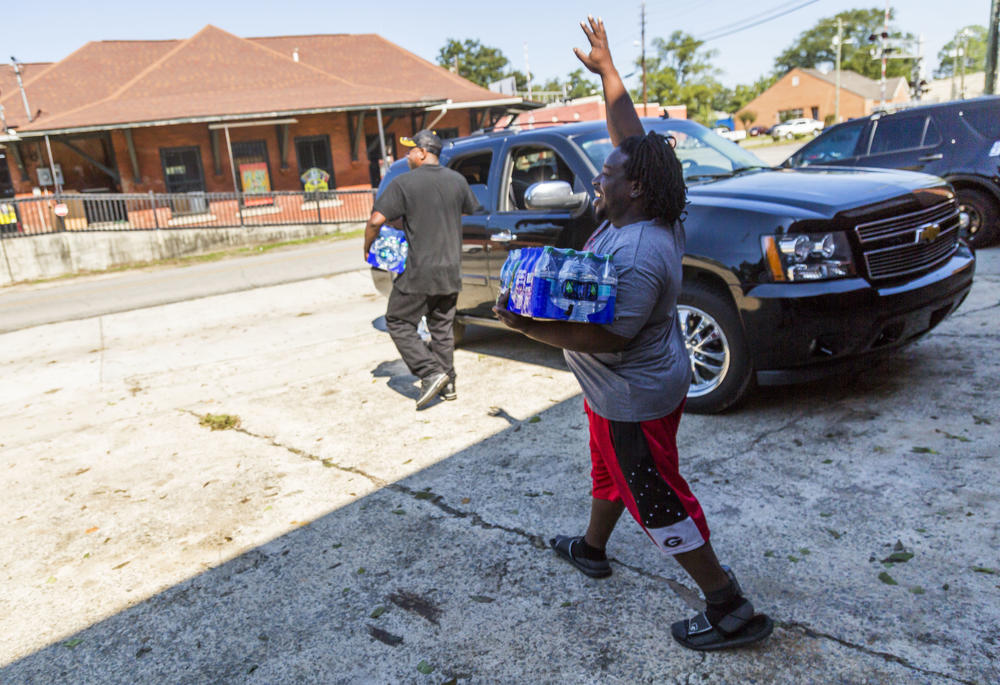 Residents of Marshalville, Ga. carry donated water. The city has had no drinkable water since Hurricane Irma knocked out a water pump behind City Hall. 