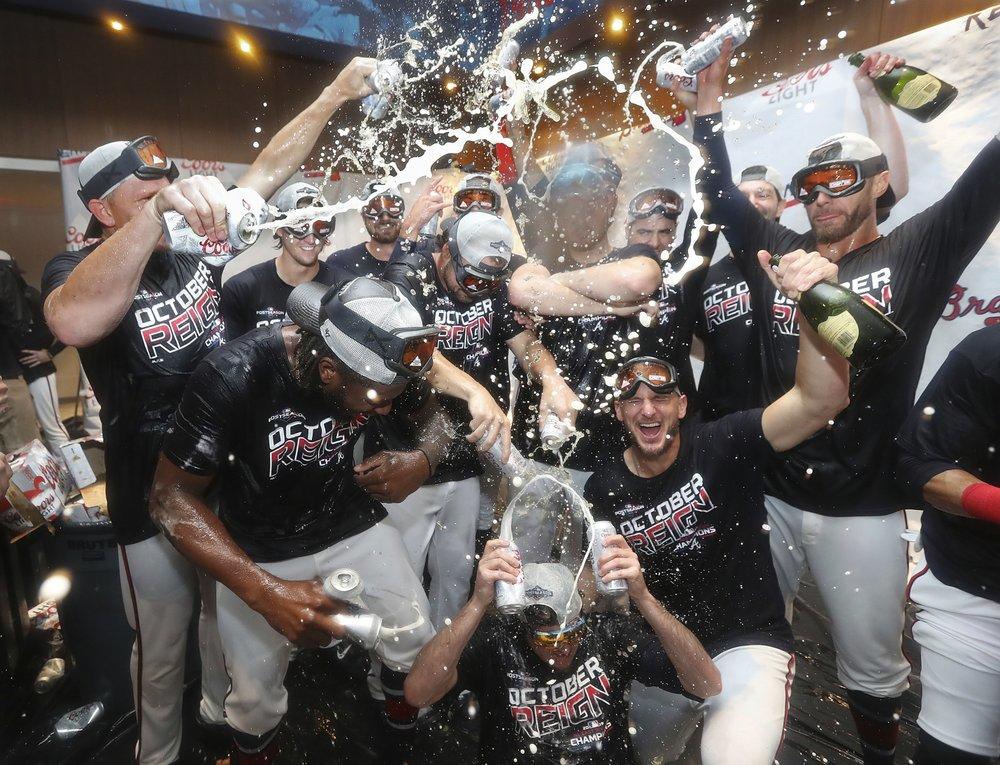 Atlanta Braves bullpen pitchers celebrate after clinching the NL East baseball title with a victory over the San Francisco Giants, Friday, Sept. 20, 2019, in Atlanta.