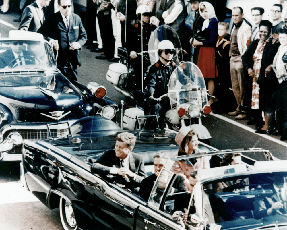 President John F. Kennedy minutes before the assassination. A popular conspiracy theory is that there were multiple shooters.