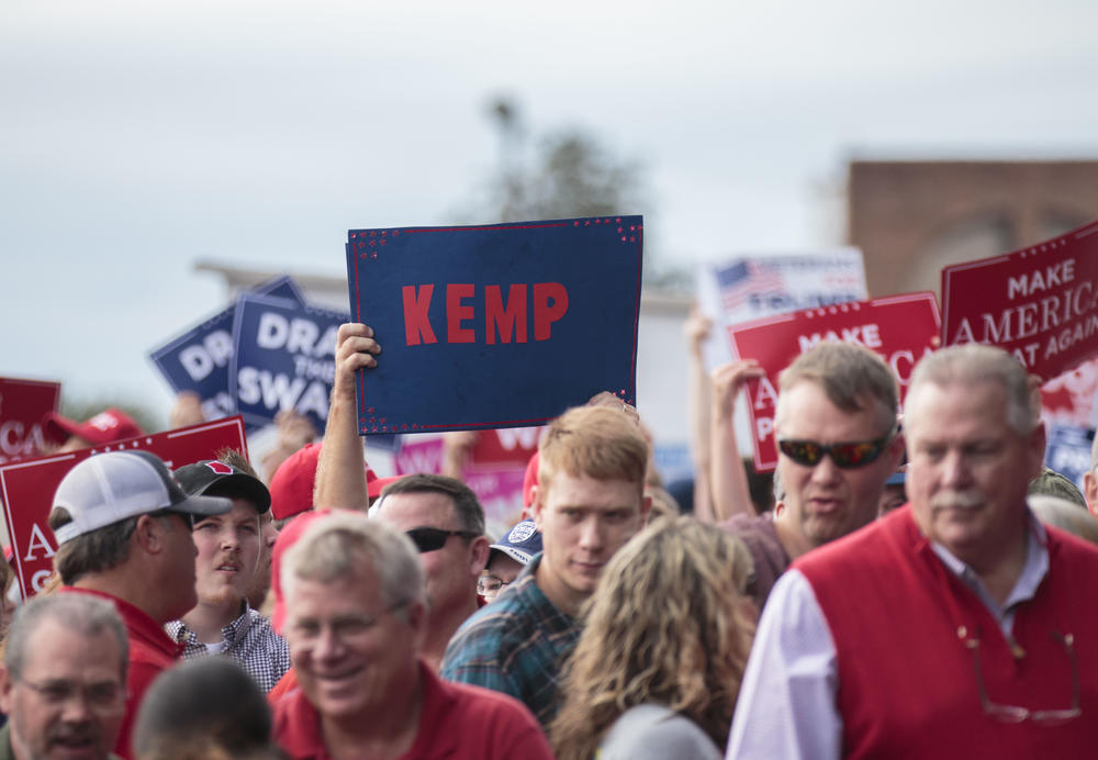 A Kemp sign in a sea of Trump signs. 