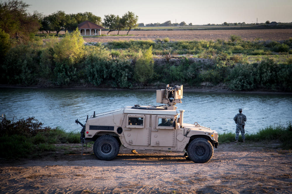 A soldier from the 36th Infantry Division, Texas Army National Guard observes a section of the Rio Grande River at sunset. He is serving at the Texas-Mexico border in support of Operation Strong Safety. 