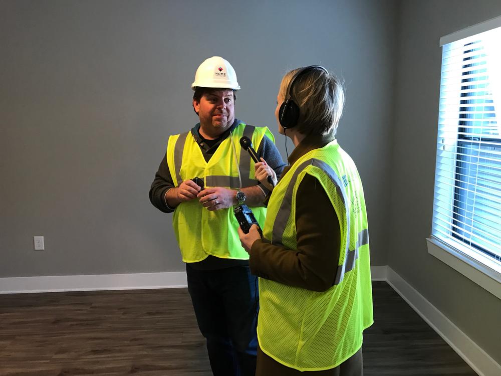 Jeff Dauler speaks to Rickey Bevington in March 2017 inside his future apartment at The Battery. 