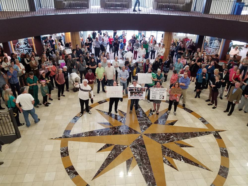 Outside Rep. Buddy Carter's town hall meeting, opponents chant 
