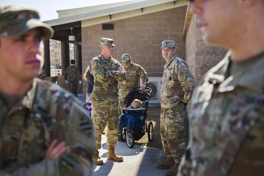 William Counihan, in his stroller, with his parents Christopher and Danielle Counihan before the Color Casing ceremony at Fort Stewart in Hinesville Tuesday. Christopher Counihan is among the members of the Army's 3rd Infantry Division who will deploy to 