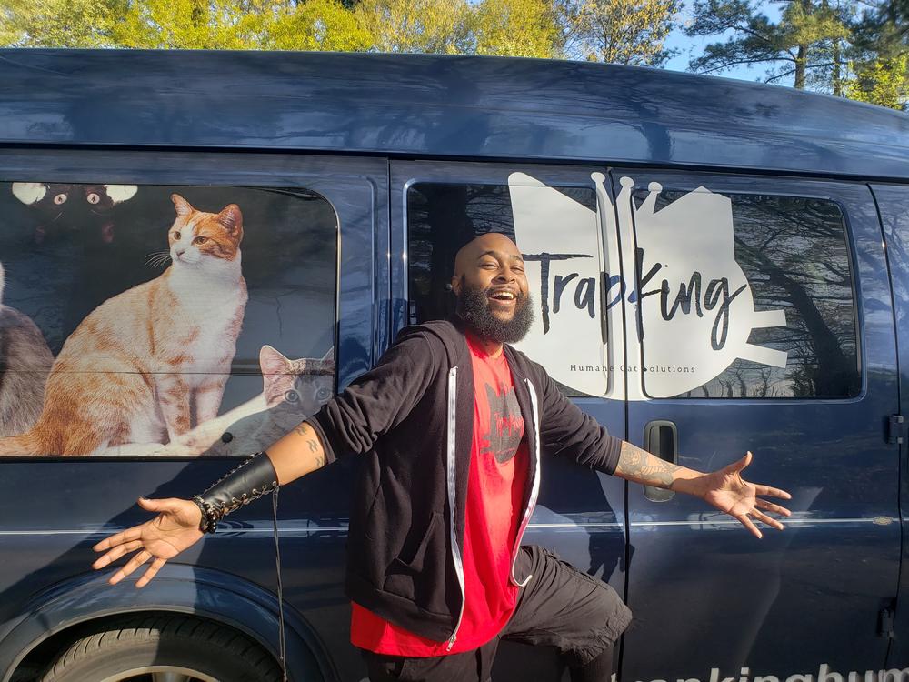 Sterling 'TrapKing' Davis poses outside of his van
