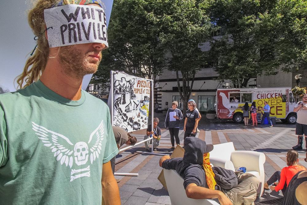 In Seattle, WA people are invited to participate in a public interactive art installation to expose racism as the
