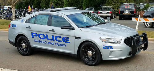 Two Athens police officers shown restraining a 10-year-old in a viral video have been cleared of accusations of excessive force.