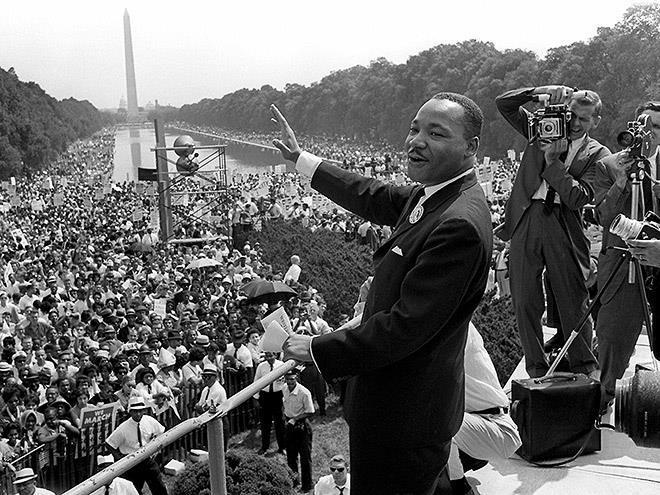 Historic photo of Martin Luther King Jr. addressing a crowd at Washington Monument.