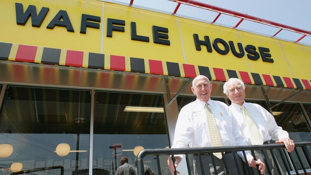 In this file photo taken July 26, 2005, Waffle House founders Joe Rogers Sr., left, and Thomas Francis Forkner Sr. pose in front of a Waffle House restaurant after eating lunch at the establishment in Norcross, Ga. Forkner died Wednesday, April 26, 2017.