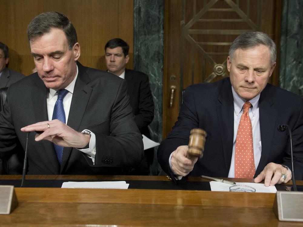 Sen. Richard Burr (right), Republican of NC and chairman of the Senate Select Committee on Intelligence, arrives alongside Sen. Mark Warner, Democrat of Virginia and Committee vice chairman, for a hearing on Russian intelligence activities on March 30.