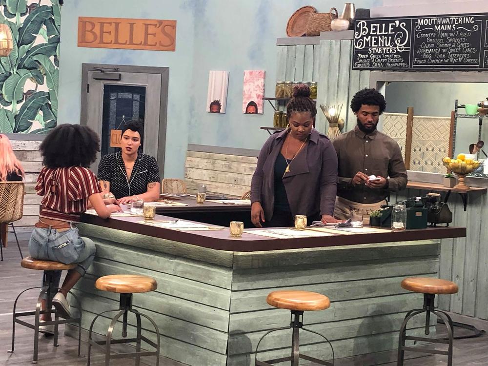 SCAD student Cori Graves, who directed G.R.I.T.S., meets with the cast on set.