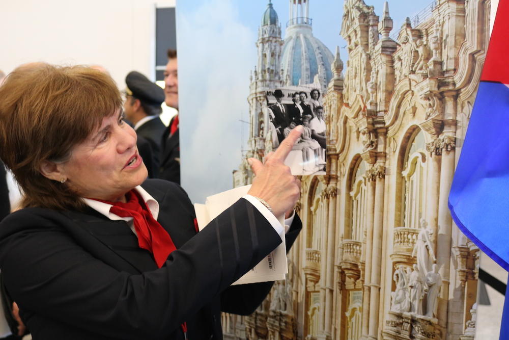 Delta flight attendant Hopie Acosta points to herself in a 1962 photo of her family in front of Miami International airport after departing from Cuba, Thursday, Dec. 1, 2016, in Atlanta, Georgia.