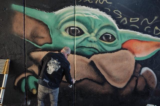 Chris Veal paints Baby Yoda along the Atlanta BeltLine.