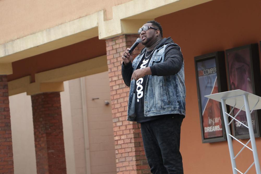 Pastor John Elmore holds church service in The 3D Church's parking lot.