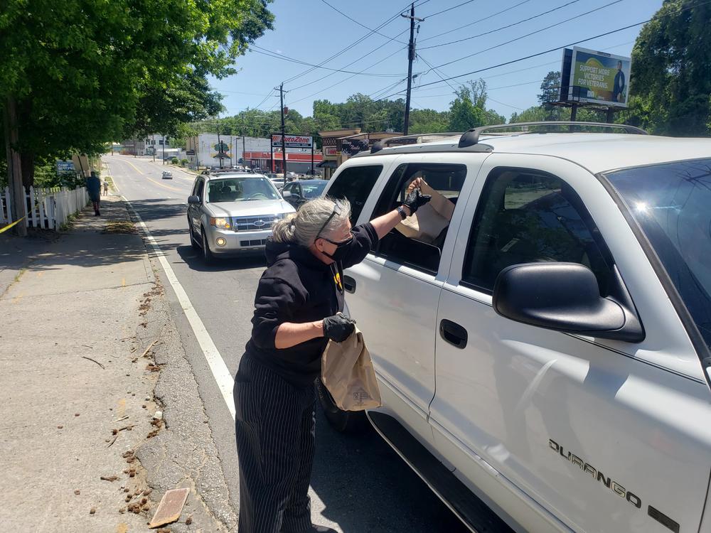 A volunteer hands out food at the Bankhead Seafood Market.