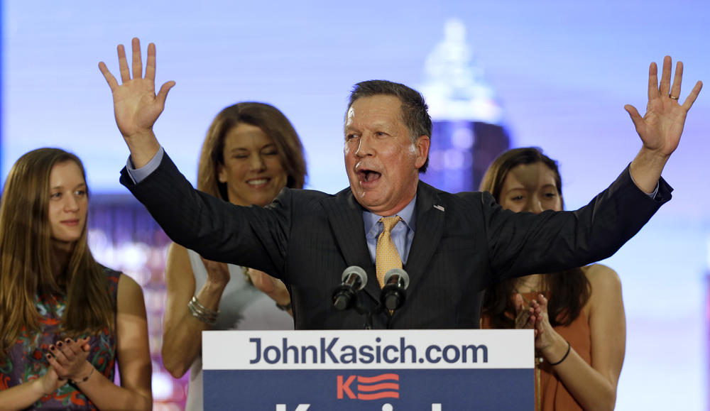 Republican presidential candidate Ohio Gov. John Kasich speaks at his presidential primary election night rally in Berea, Ohio, on Tuesday, March 15, 2016. His wife, Karen, and daughters, Emma, left, and Reese listen. 