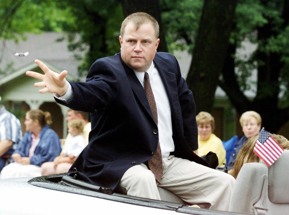 Richard Jewell, parade grand marshal, tosses candy to spectators along the parade route in Carmel, Ind., in 2001. Jewell, who was the focus of an FBI investigation for the 1996 Olympic Park bombing, was being honored as one of the nation's unsung heroes. 