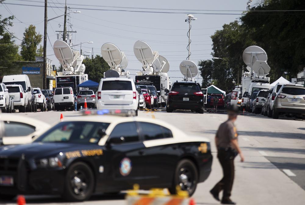 Satellite dishes sit atop television news trucks as members of the media report from near the scene of a mass shooting at the Pulse nightclub Monday, June 13, 2016, in Orlando, Fla.