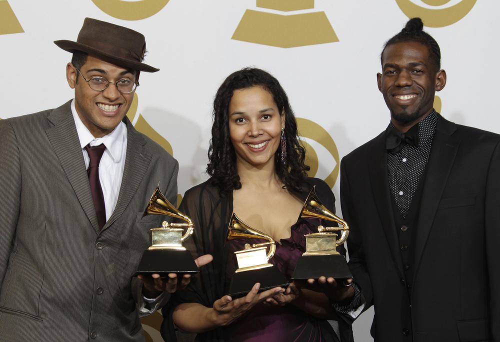Musicians Dom Flemons, Rhiannon Giddens and Justin Robinson, of the Carolina Chocolate Drops, pose with the award for best traditional folk album at the Grammy Awards. Their music is inspired by the Appalachian region.