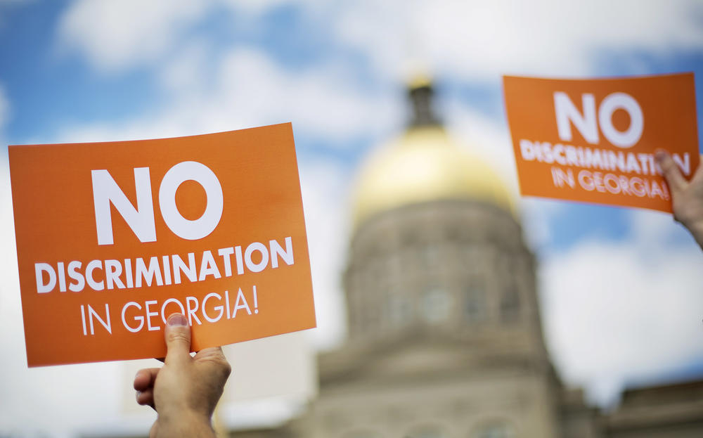 Protestors rally at the state Capitol in opposition to 