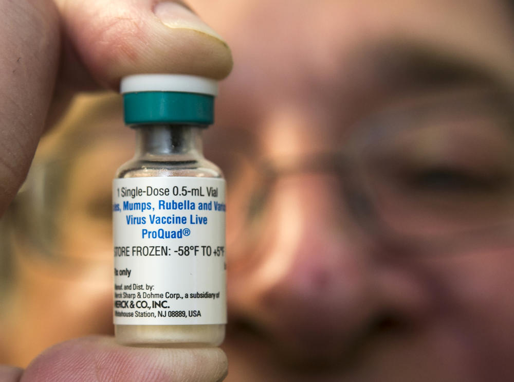 In this Thursday, Jan. 29, 2015 file photo, a pediatrician holds a dose of the measles-mumps-rubella (MMR) vaccine at his practice in Northridge, Calif. 