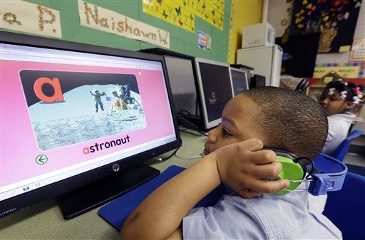 J'son Hayes works on a computer in his prekindergarten class at a public school.
