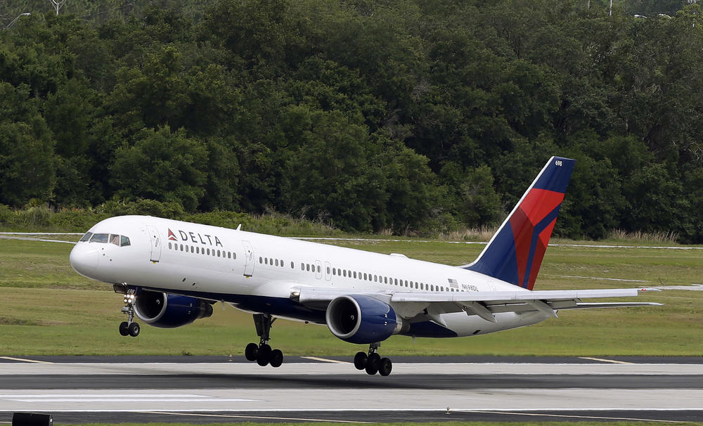 FILE - In this Thursday, May 15, 2014, file photo, a Delta Air Lines Boeing 757-232 lands at the Tampa International Airport in Tampa, Fla.