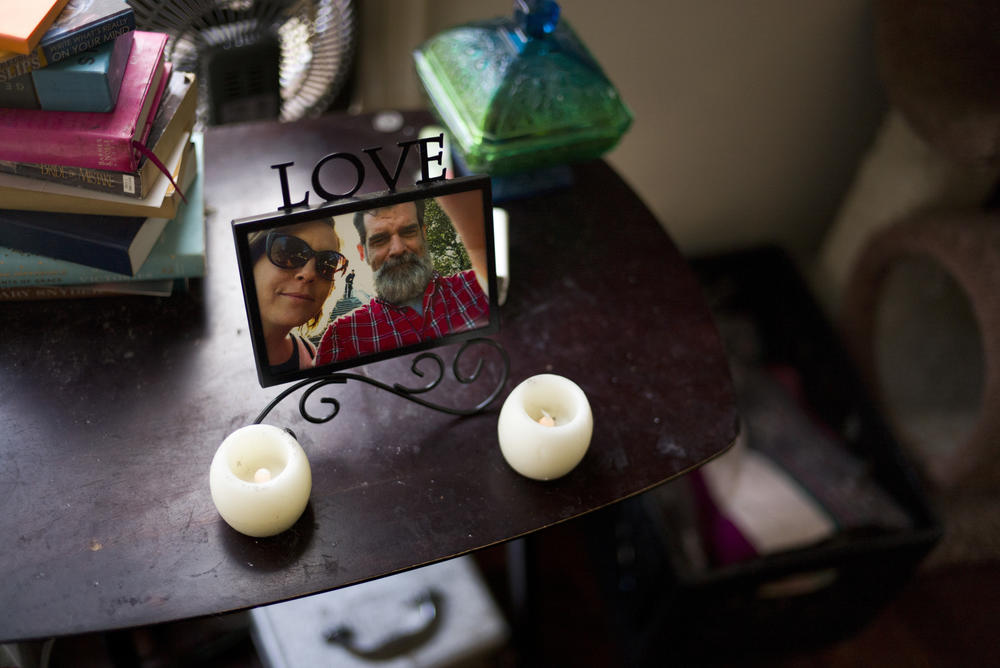 In this Thursday, May 19, 2016 photo, a framed photo of Mandy Pifer and her boyfriend, Shannon Johnson, is placed next to her bed in Los Angeles. Nearly six months ago, Johnson was one of the 14 people killed in the San Bernardino terrorist attack. 