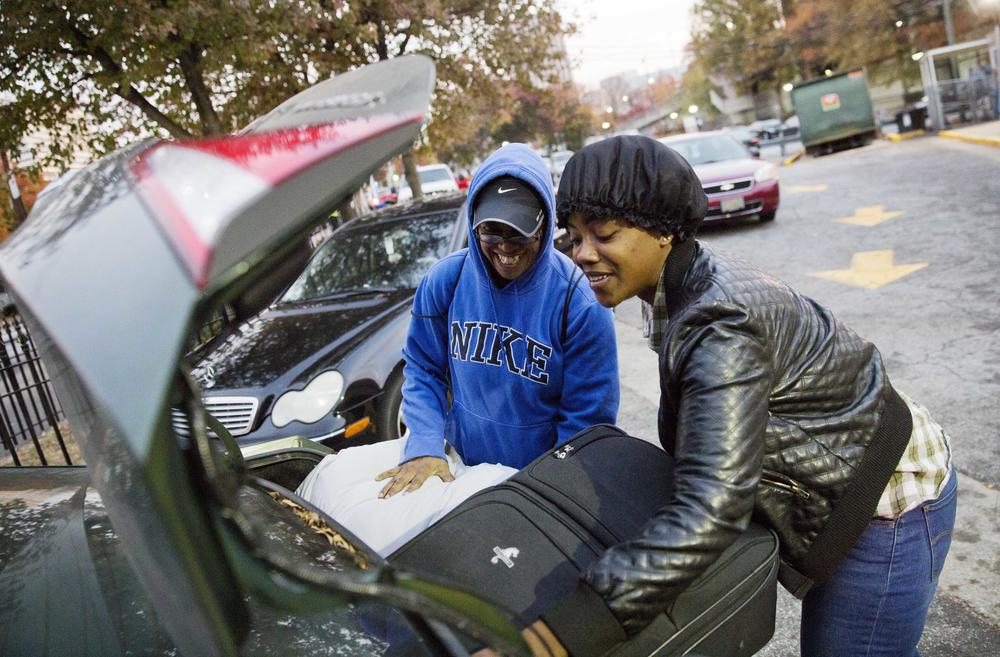 April Traylor, of Nashville, Tenn., left, is helped by her daughter Latisha Brown to load her bags into the car after arriving on a bus to spend the Thanksgiving holiday in Atlanta, Wednesday, Nov. 23, 2016.
