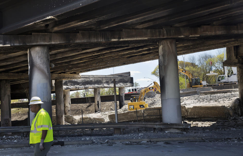 In this Friday, March 31, 2017 file photo, construction crews work on a section of an overpass that collapsed from a large fire that started Thursday afternoon on Interstate 85 in Atlanta.