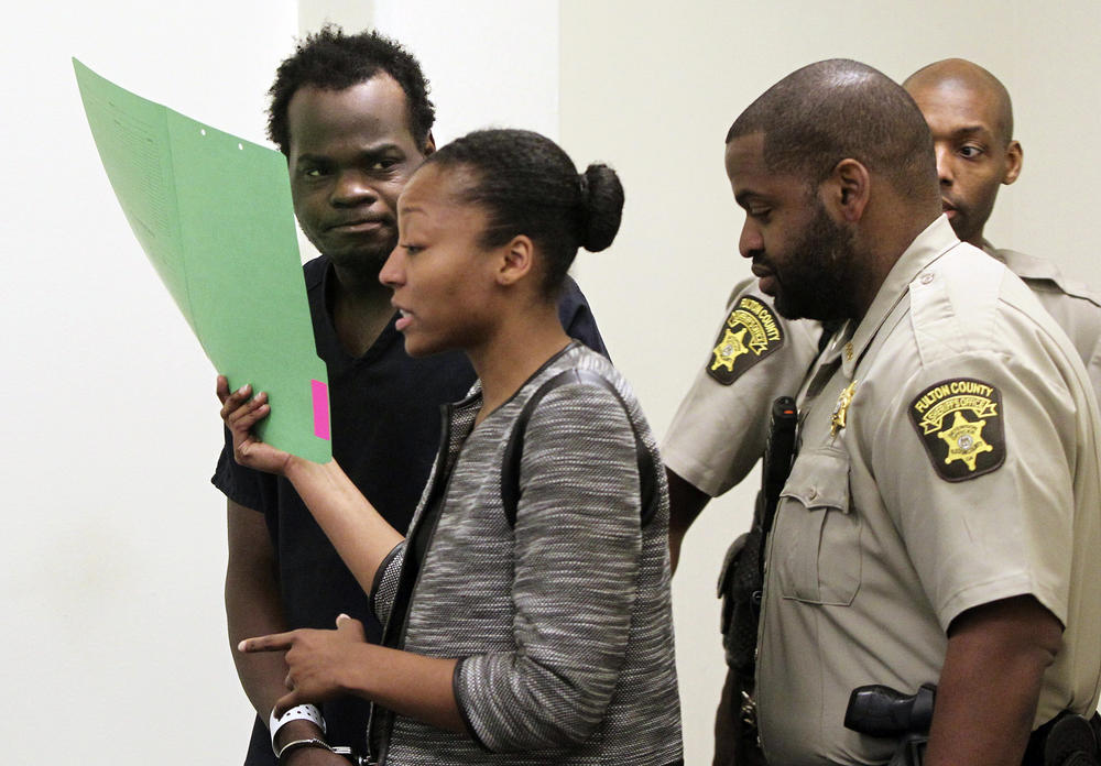 Basil Eleby is escorted by his public defender and two Fulton County Sheriff's office officers into the court room at the Fulton County Jail in Atlanta on Saturday, April 1, 2017.