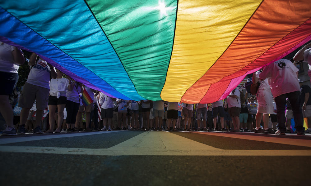 Marchers unfurl a huge rainbow flag as they prepare to march in the Equality March for Unity and Pride in Washington, Sunday, June 11, 2017.