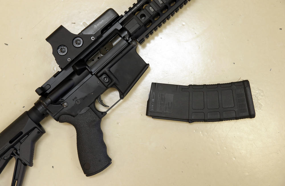 FILE - This Oct. 3, 2013 file photo shows a custom-made semi-automatic hunting rifle with a high-capacity detachable magazine is displayed at a gun store in Rocklin, Calif. 