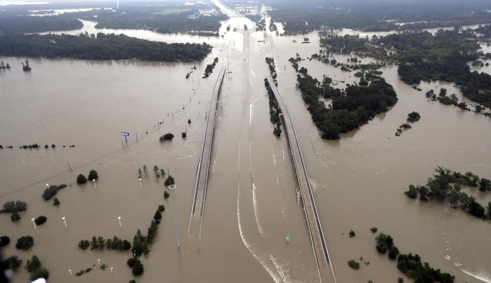 In this Aug. 29, 2017 file photo, Interstate 69 is covered by floodwaters from Harvey, in Humble, Texas. 