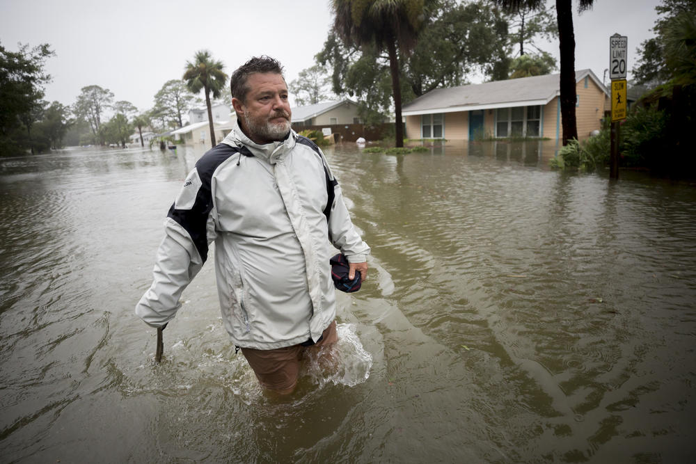 Joey Spalding walks back to his truck down the street where he lives, Monday, Sept., 11, 2017, on Tybee Island, Ga. He said the Tropical Storm Irma brought three feet of storm surge into his living room.