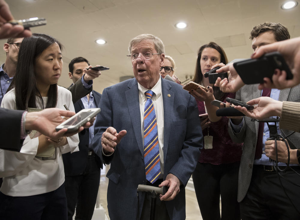Sen. Johnny Isakson, R-Ga., a member of the tax-writing Senate Finance Committee, takes questions from reporters as he and other lawmakers head to the Senate floor for votes on Capitol Hill in Washington, Monday evening, Nov. 27, 2017. 