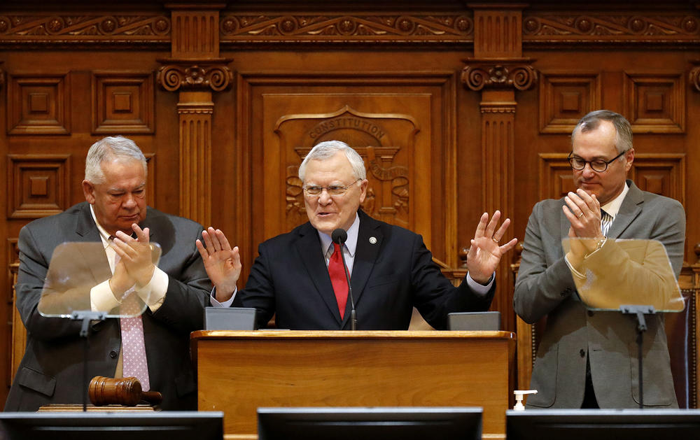 Georgia Gov. Nathan Deal delivers the State of the State address on the House floor while applauded by Lt. Gov. Casey Cagle, right, and House Speaker David Ralston at the state Capitol in Atlanta, Thursday, Jan. 11, 2018. 