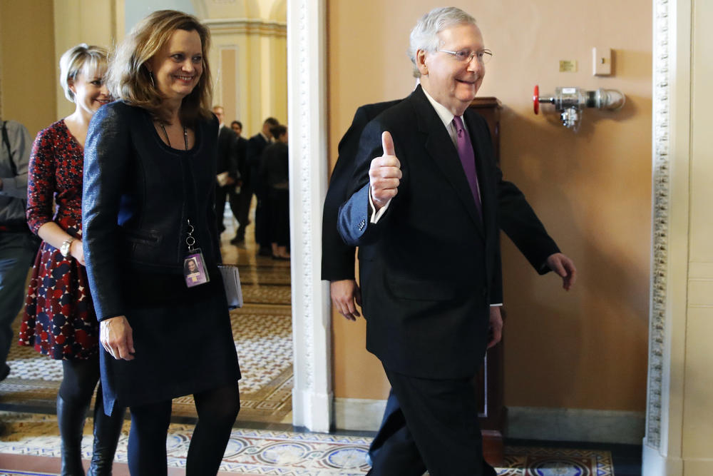 Senate Majority Leader Mitch McConnell of Ky., makes the thumbs up sign as he leaves the Senate floor after reaching an agreement to advance a bill ending the government shutdown, Monday Jan. 22, 2018.
