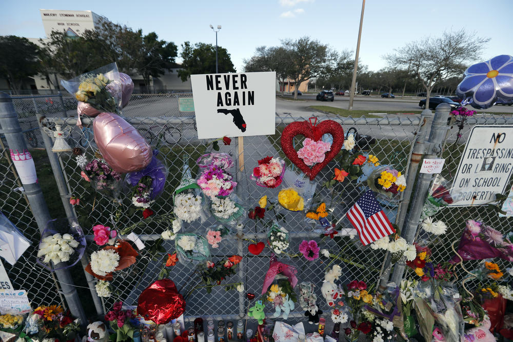 A makeshift memorial is seen outside the Marjory Stoneman Douglas High School, where 17 students and faculty were killed in a mass shooting on Wednesday, in Parkland, Fla.