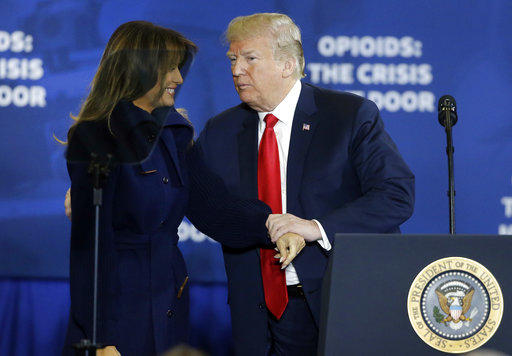 President Donald Trump clasps hands with first lady Melania Trump as he takes the podium to speak about his plan to combat opioid drug addiction at Manchester Community College, Monday, March 19, 2018, in Manchester, N.H.