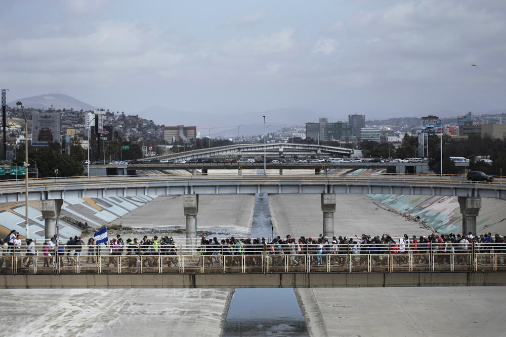 In this April 29, 2018 photo, Central Americans who travel with a caravan of migrants they walk towards the border before crossing the border and request asylum in the United States, in Tijuana, Mexico.