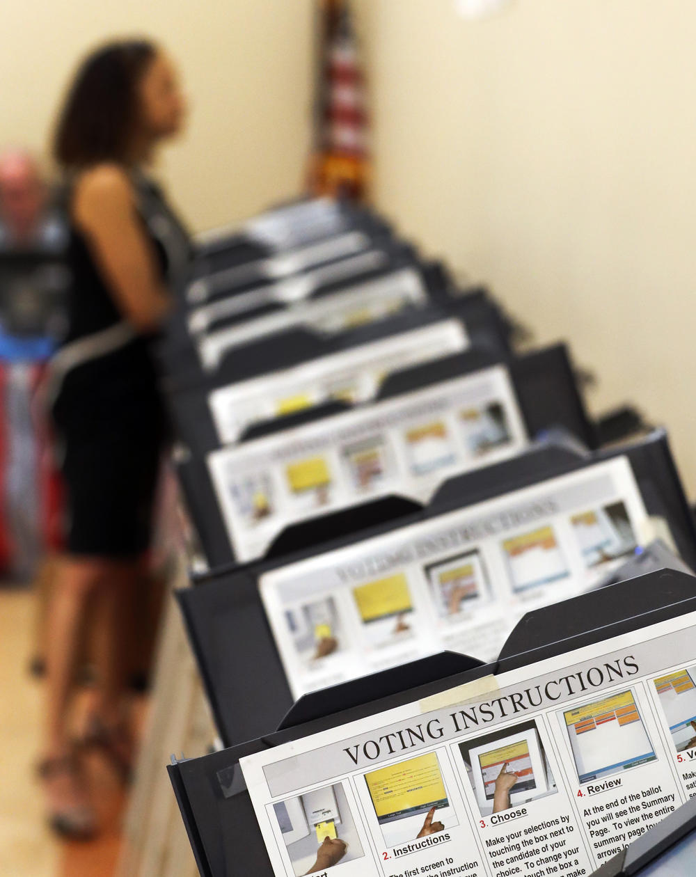 In this Wednesday, May 9, 2018, photo, Pamela Hampton votes in Sandy Springs, Ga.