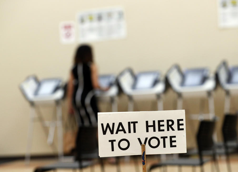 In this Wednesday, May 9, 2018, photo, Pamela Hampton votes in Sandy Springs, Georgia.