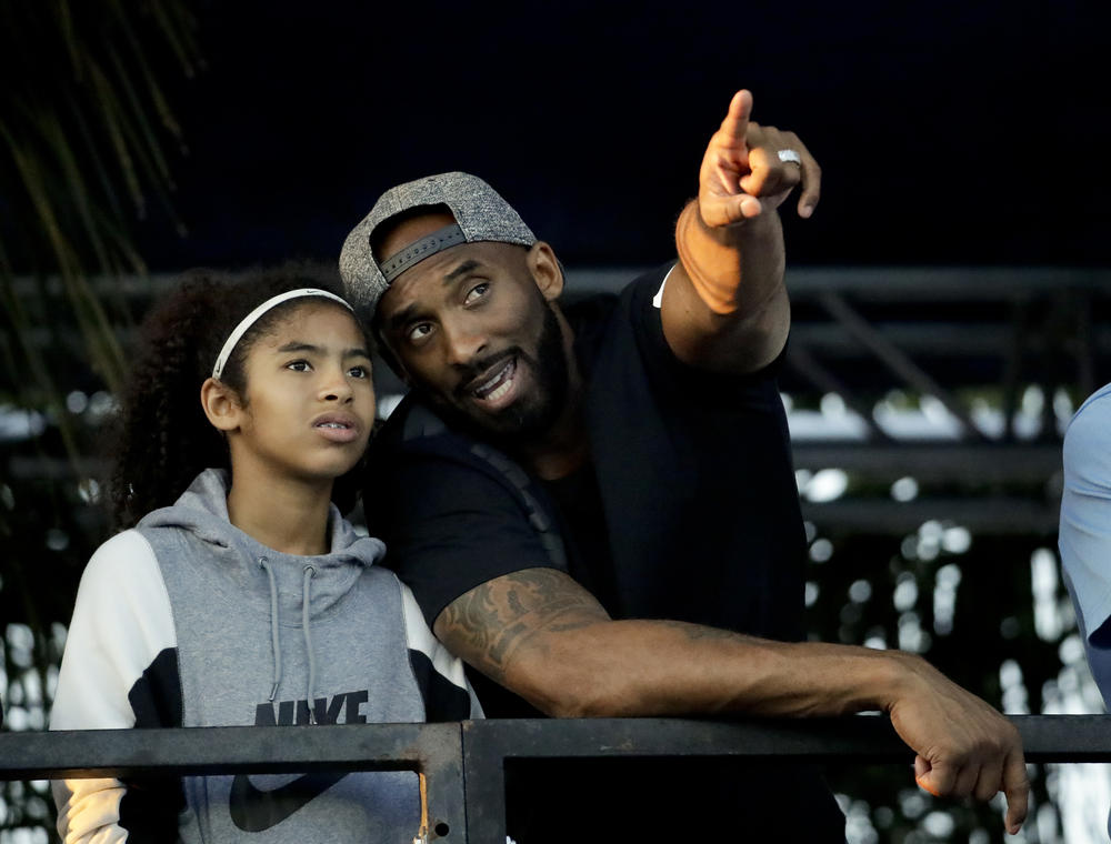 Kobe Bryant and his daughter Gianna watch the U.S. national championships swimming meet Thursday, July 26, 2018, in Irvine, Calif.
