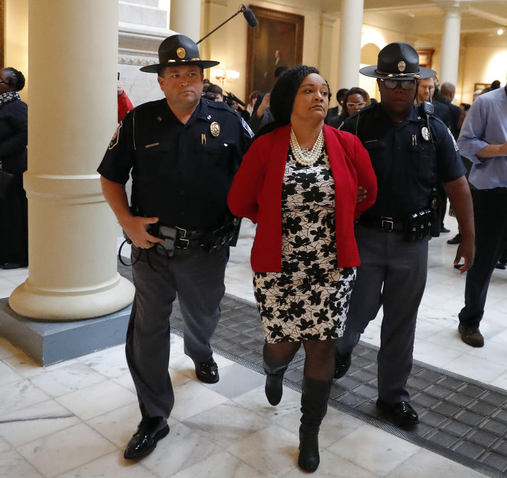 Sen. Nikema Williams (D-Atlanta) is arrested by capitol police during a protest over election ballot counts in the rotunda of the state capitol building Tuesday, Nov. 13, 2018, in Atlanta.