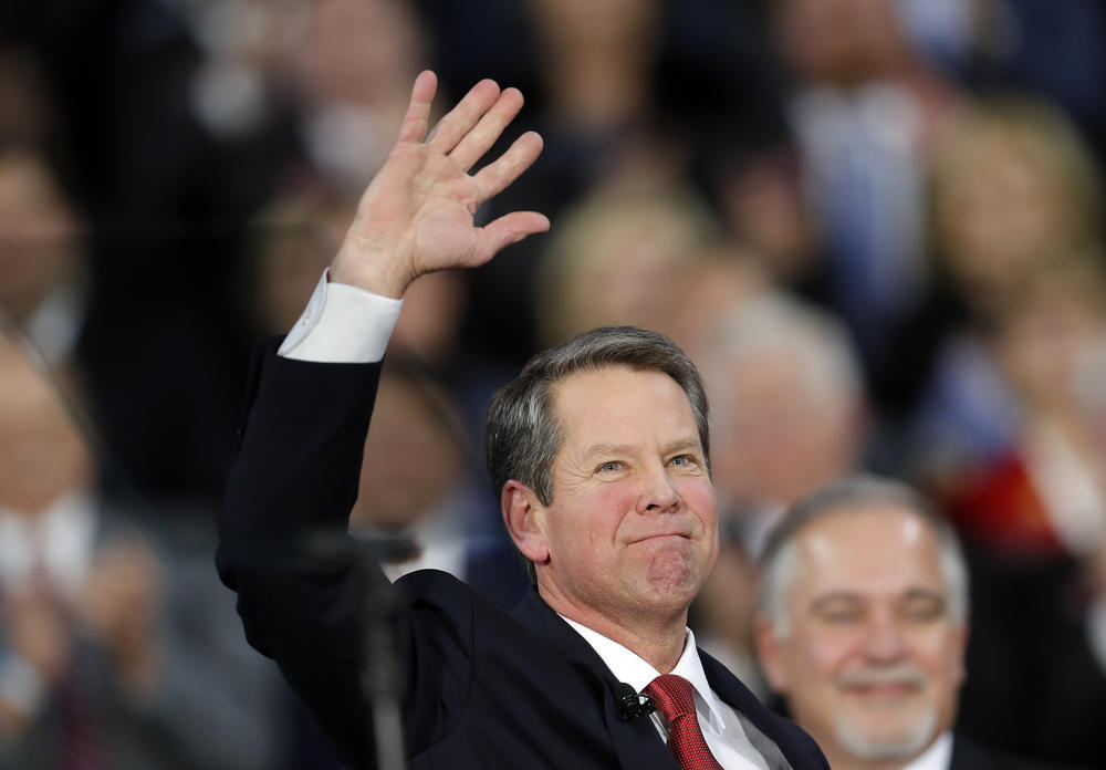 Brian Kemp waves after being sworn in as Georgia's governor during a ceremony at Georgia Tech's McCamish Pavilion in Atlanta.