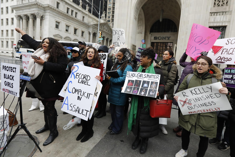 Sonja Spoo, left, associate campaign director of Ultra Violet, leads chants during an R. Kelly protest outside Sony headquarters, in New York, Wednesday, Jan. 16, 2019.