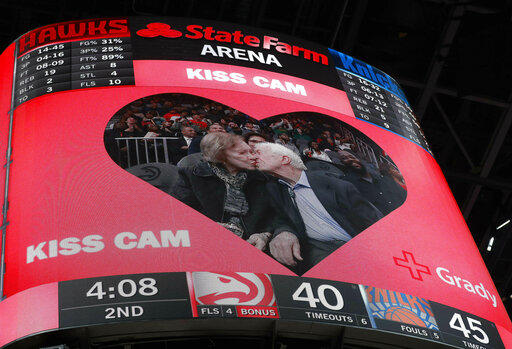 Former President Jimmy Carter kisses his wife, Rosalynn, after the two were spotted by the 'kiss cam